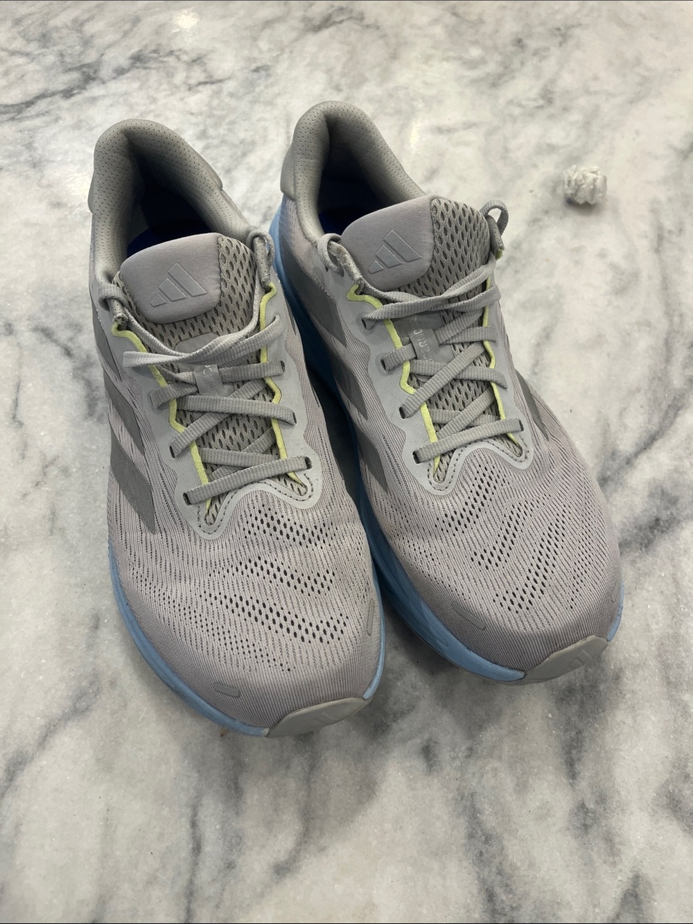 adidas Men’s Light Gray Running Shoes with Blue Sole and Lime Accents. Supernova